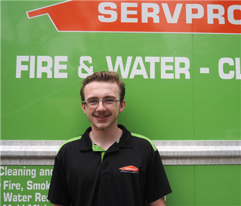 SERVPRO employee in front of green background