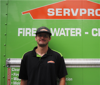 SERVPRO employee in front of green background