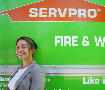 SERVPRO employee pictured in front of green background