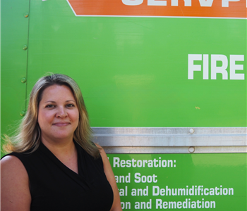 SERVPRO employee pictured in front of green background
